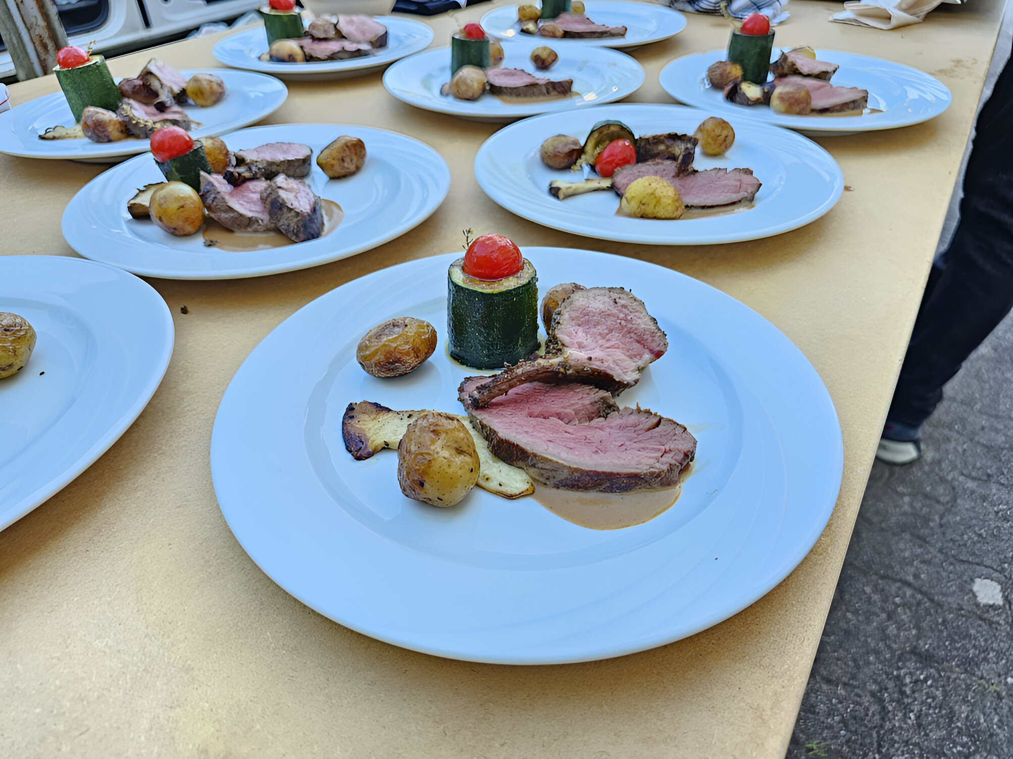 Fleisch, Kartoffeln, Tomaten, Zucchini angerichtet auf Teller nach Grill-Event mit Freddy Camerer von XXL-BBQ auf Spiessgrill von unico swiss